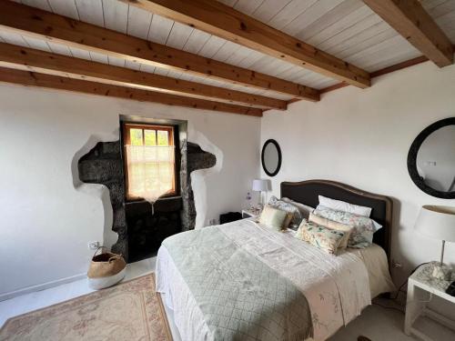a bedroom with a bed and a window at Waka Sun Rise Pico Azores in Cais do Pico