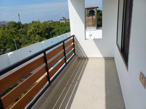 a balcony of a house with a view at Tulivu Suites Diani in Ukunda