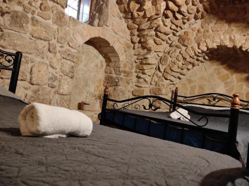 a bedroom with a bed in a stone wall at New Citadel Hostel in Jerusalem