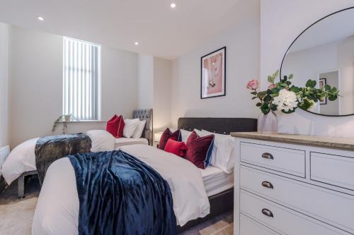 a bedroom with two beds and a mirror at Modern Flat in Leeds by PureStay Short Stays in Leeds