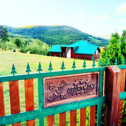 a fence with a sign in front of a barn at Ethno village & resort Ćorić in Mojkovac