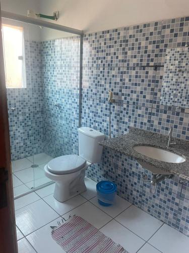 a bathroom with a toilet and a sink at Chalés em Ilhabela in Ilhabela