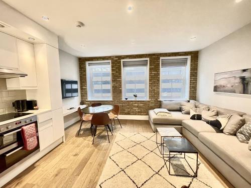 a living room with a couch and a table at Drury Lane Residences in London