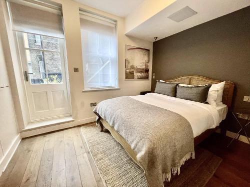 a bedroom with a large bed and a window at Drury Lane Residences in London