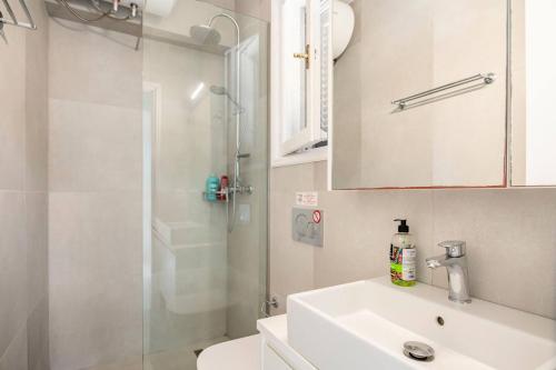 a bathroom with a shower and a sink and a toilet at Agapi mou in Glyfada