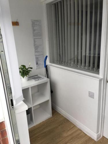 a room with a door with a radiator at Little Owl Self Catering in Little Barningham