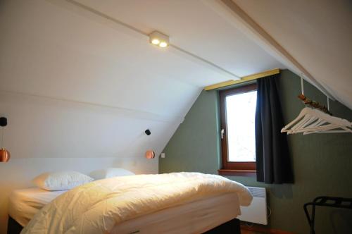 a room with two beds and a window at Maison du Lac 14 in Vielsalm