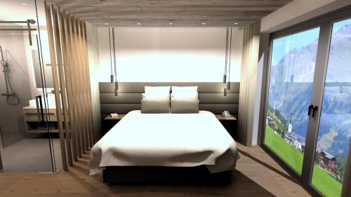 ein Schlafzimmer mit einem weißen Bett und einem großen Fenster in der Unterkunft Jaggling Appartements in Sankt Ulrich am Pillersee