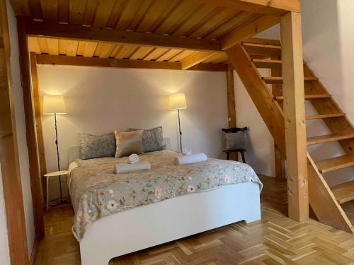 a bedroom with a large wooden bed with two lamps at Knézits Spacious AC Terrace Free Parking in Budapest