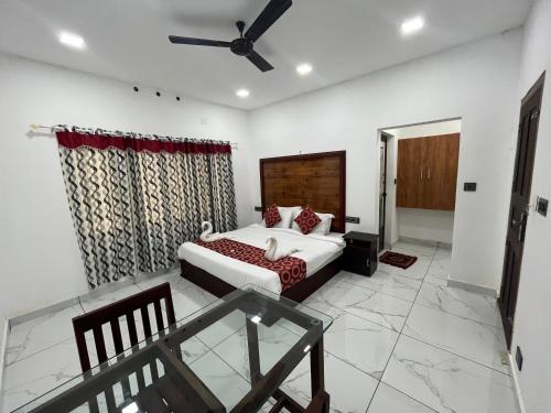 a bedroom with a bed and a ceiling fan at Mount court munnar in Munnar