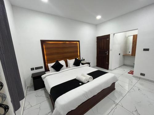 a bedroom with a large bed with a wooden headboard at Mount court munnar in Munnar
