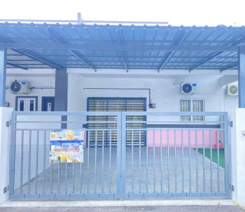 a blue gate in the front of a building at WawAmir Homestay @ Seri Iskandar in Seri Iskandar