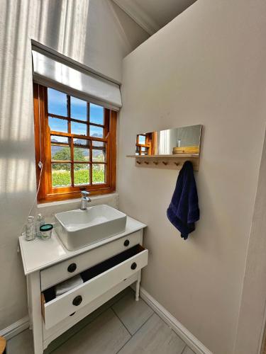 a bathroom with a sink and a window at Camberley Wines - Luxury Accommodation in Stellenbosch