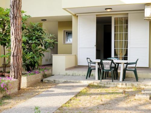 a patio with a table and chairs in front of a house at Apartment Veranda-6 by Interhome in Rosapineta