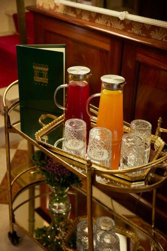 a tray of glasses and bottles of juice on a table at Duodo Palace in Venice