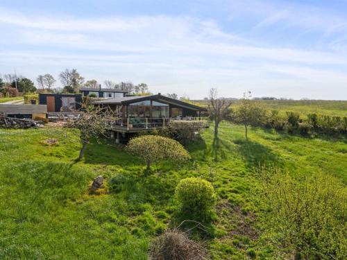 a house in the middle of a field at Holiday Home Geeske - 150m from the sea in Funen by Interhome in Middelfart