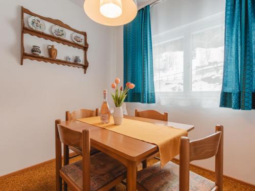 a dining room with a wooden table and chairs at Apartment Alpenpanorama by Interhome in Bad Gastein