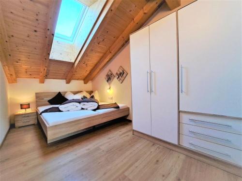 a bedroom with a bed and a skylight at Apartment Margret- Top 12 by Interhome in Gagering