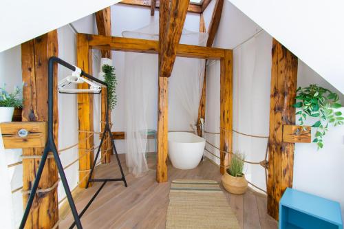 a bathroom with a ladder and a tub in a room at Duplex apartment in the center of Krakow in Krakow