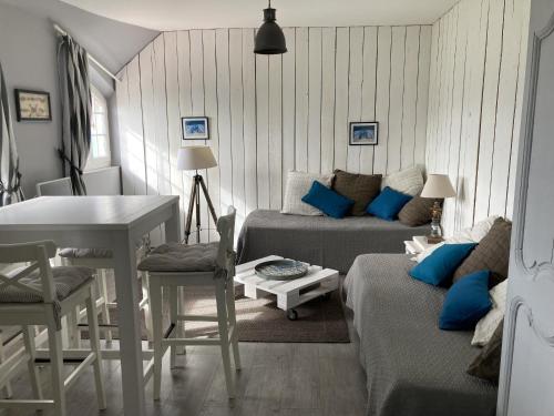 un salon avec un canapé et une table dans l'établissement Mouettes, à Hautot-sur-Mer