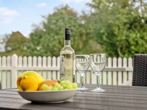 een tafel met een fruitschaal en een fles wijn bij Apartment Aava - all inclusive - in Western Jutland by Interhome in Højer