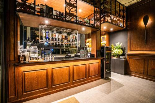a bar in a restaurant with a counter at Chainam-Charmchuree residences cafe and spa in Ban Bang Bua Thong