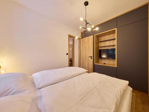 a bedroom with a large white bed and a window at Apartment Máj-6 by Interhome in Pec pod Sněžkou