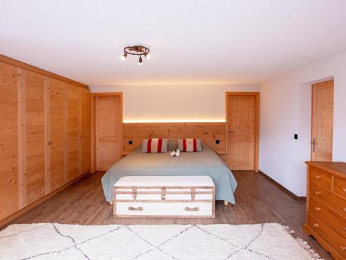 a bedroom with a bed and wooden walls at Chalet Chalet les Pars by Interhome in Gryon
