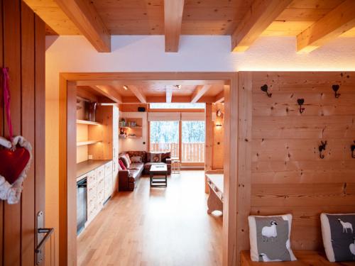 a kitchen and living room with wooden walls at Chalet Chalet Les Pars by Interhome in Gryon