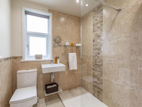 a bathroom with a toilet and a sink and a shower at 2 Bed in Dalmally CA379 in Dalmally