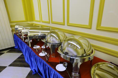 a row of tables in a room with blue chairs at Muscat International Hotel Plaza in Salalah
