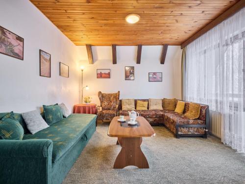 a living room with a couch and a table at Villa Svoboda nad Úpou by Interhome in Svoboda nad Úpou