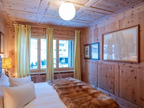 a bedroom with a bed and a large window at Apartment Chesa Arlas C4 by Interhome in St. Moritz