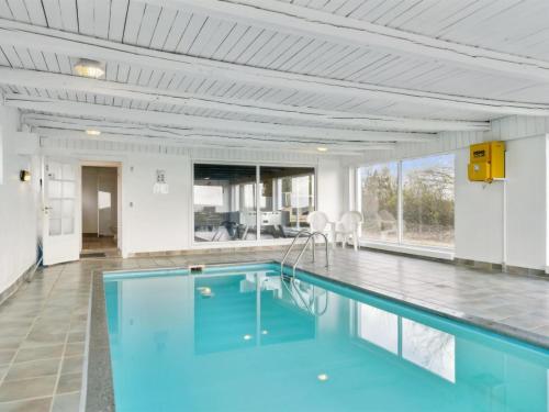 a swimming pool with blue water in a house at Holiday Home Sune - 6km from the sea in NW Jutland by Interhome in Thisted