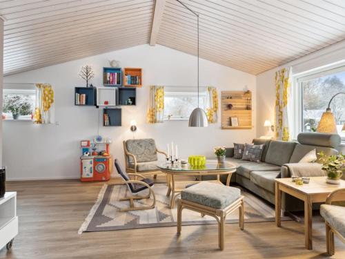 ein Wohnzimmer mit einem Sofa und einem Tisch in der Unterkunft Holiday Home Oskari - 175m from the sea in Sealand by Interhome in Slagelse
