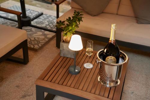 a table with a bottle of wine and a lamp at Duodo Palace in Venice