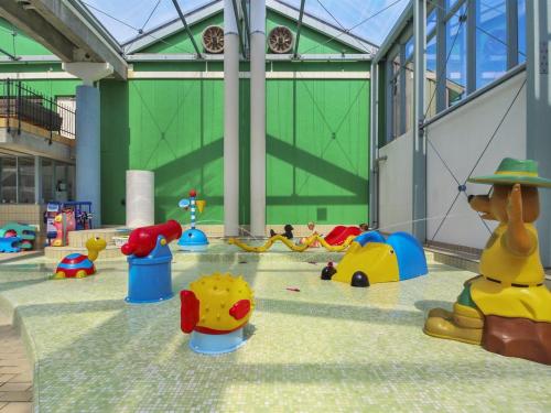 a childrens play area with many toys in a building at Holiday Home Tian in SE Jutland by Interhome in Gjern