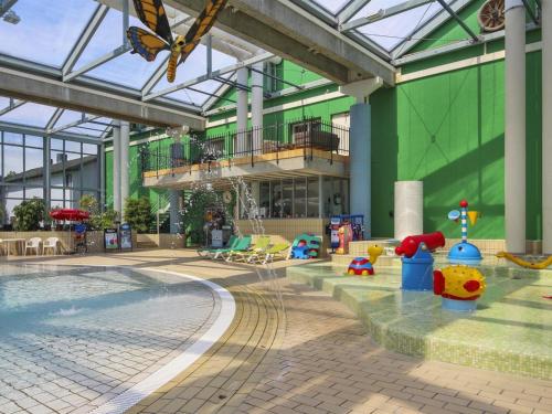 a large building with a swimming pool and a butterfly at Holiday Home Tian in SE Jutland by Interhome in Gjern
