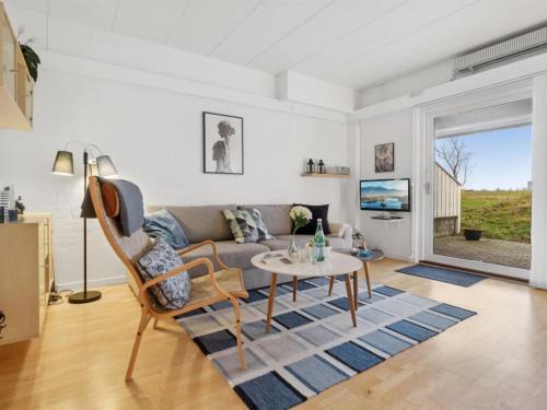 - un salon avec un canapé et une table dans l'établissement Holiday Home Thorulf - 6km from the sea in Bornholm by Interhome, à Åkirkeby