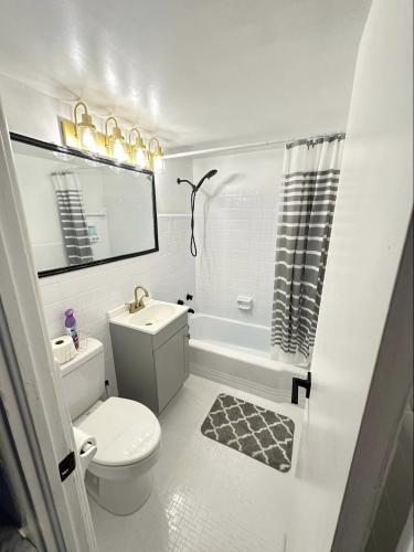 a white bathroom with a toilet and a sink at OCEAN FRONT Condo On The Beach in Daytona Beach