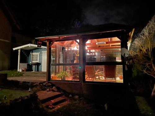 a house with a screened in porch at night at Kleinod Dittmannsdorf 