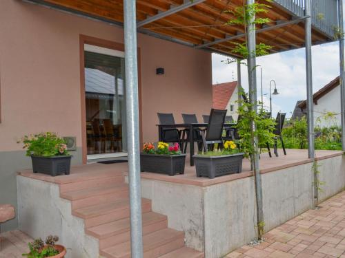 a patio with potted plants on a house at Apartment Altes Zollhaus-1 by Interhome in Fischbach bei Dahn