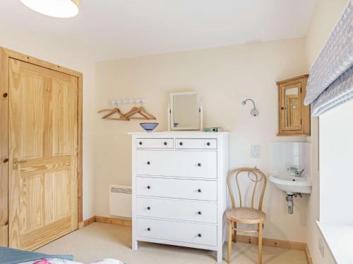 a bedroom with a white dresser and a sink at 4 Bed in Grantown-on-Spey CA383 