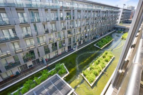 a large building with a garden in front of it at Stylish 1-Bed Flat with Sofa-Bed in London in London
