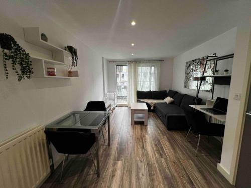 a living room with a couch and a table at Stylish 1-Bed Flat with Sofa-Bed in London in London