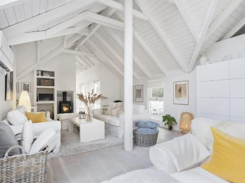 a living room with white furniture and a white ceiling at Holiday Home Verner - 900m from the sea in NW Jutland by Interhome in Fjerritslev