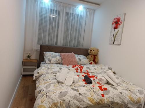 a bed in a bedroom with a teddy bear on it at Apartman ''Airplane'' Sarajevo in Sarajevo