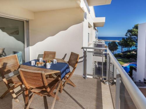 a balcony with a table and chairs and the ocean at Apartment Cala Llobeta by Interhome in L'Ametlla de Mar