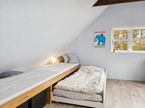 a bedroom with a bed and a window at Holiday Home Hughlek - 1-5km from the sea by Interhome in Gedser