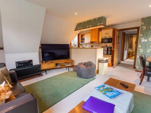 a living room with a couch and a table at Chalet Caledonia Lodge by Interhome in Spean Bridge
